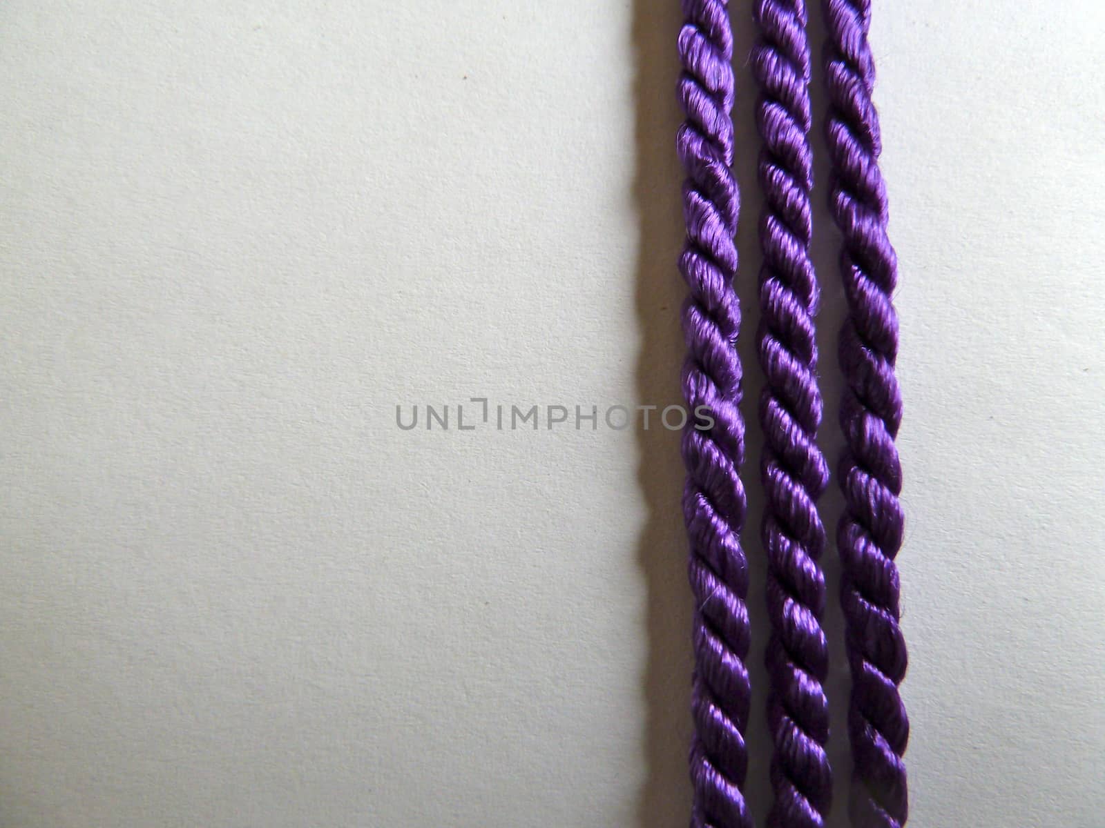 Three bright purple lines of cotton rope