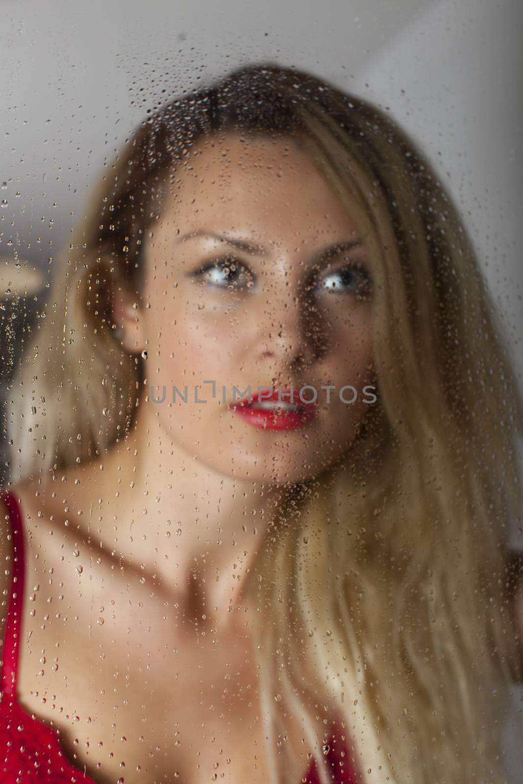 woman in lingerie seen through a window
