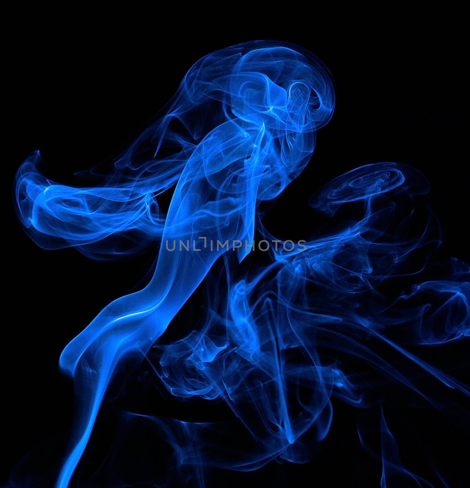 Smoke rising makes interesting shapes on a black background