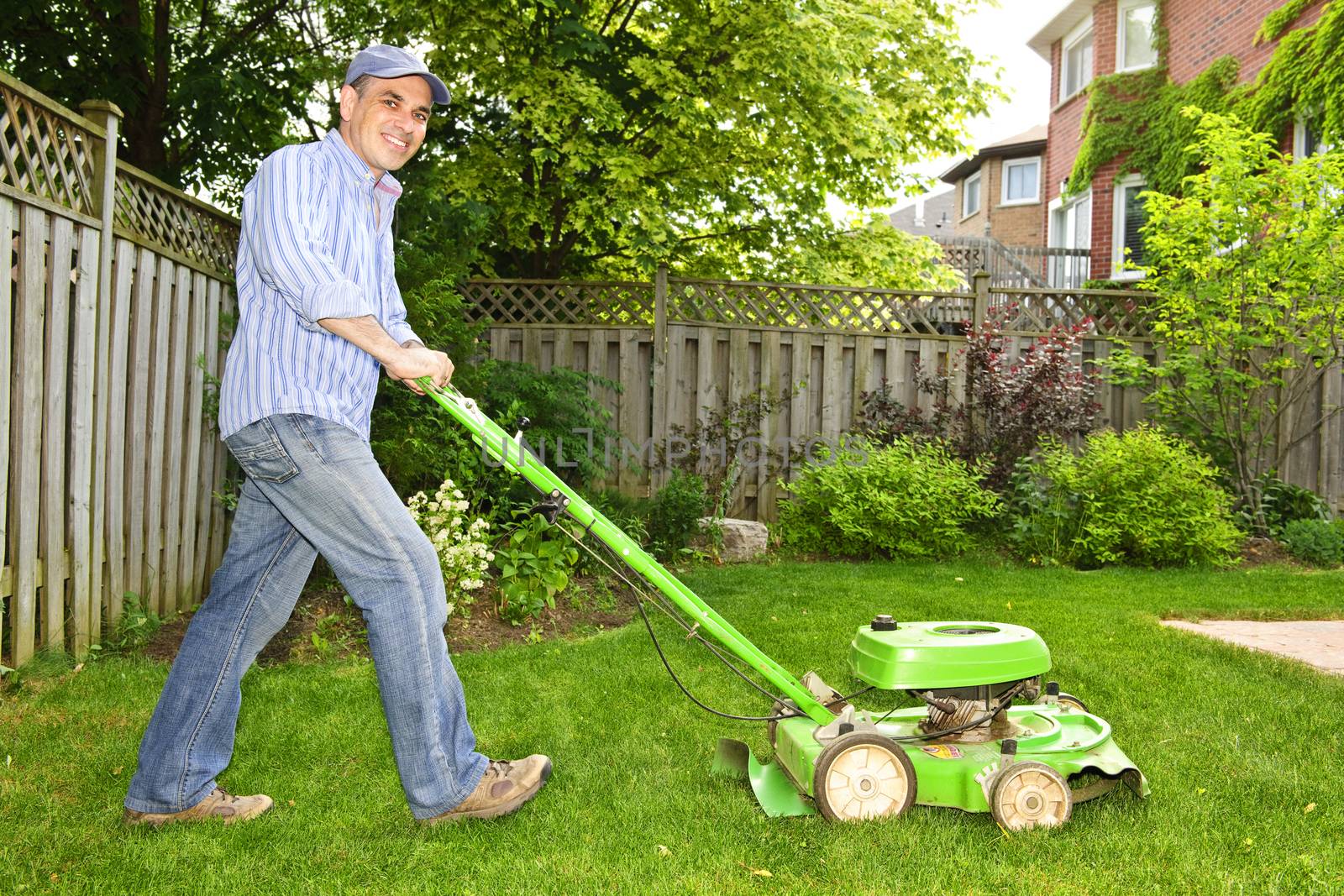 Man mowing lawn by elenathewise