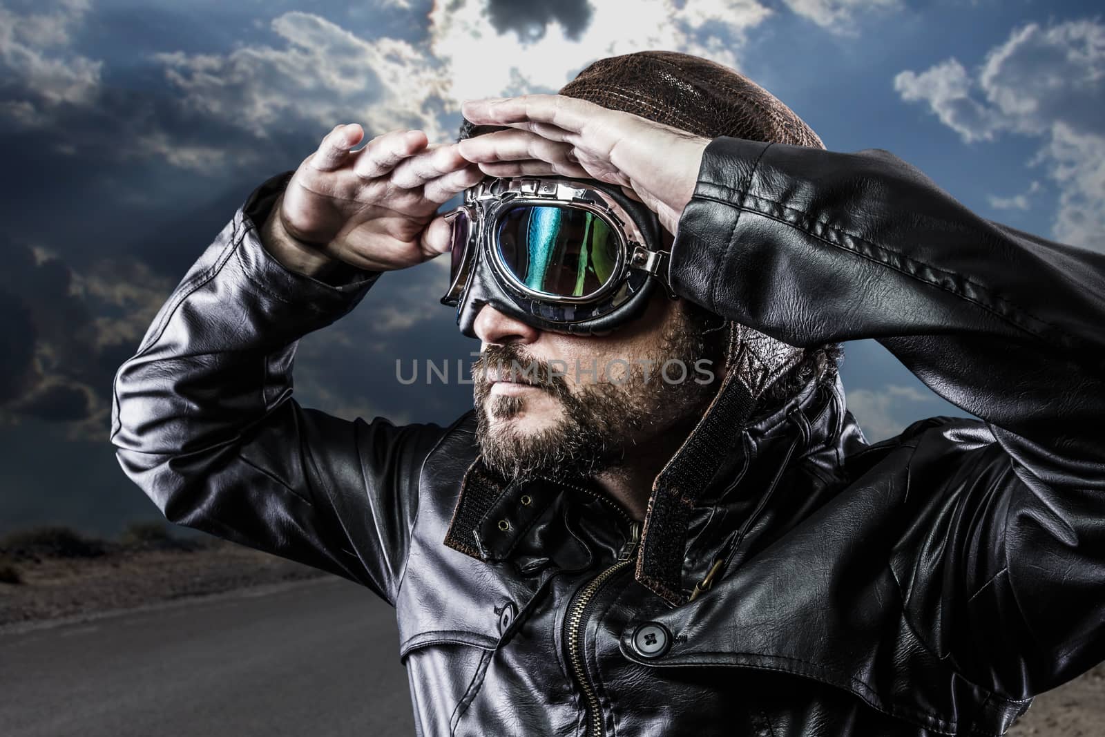 biker with black leather jacket and old glasses