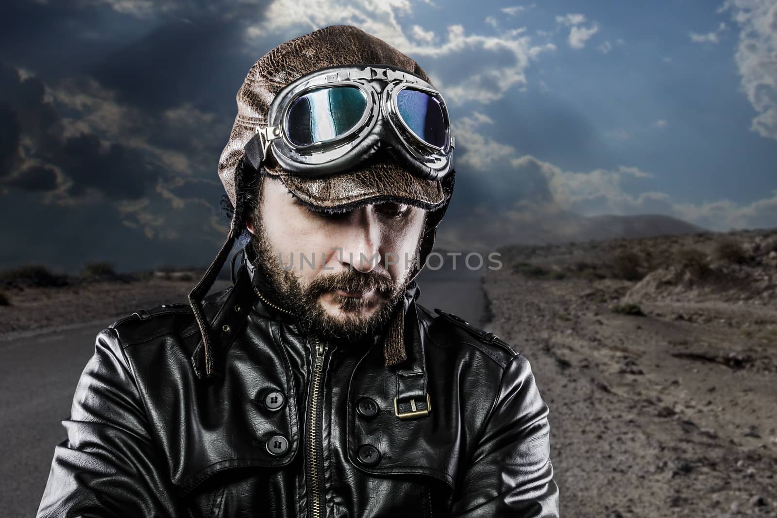 Serious biker with black leather jacket and old glasses by FernandoCortes