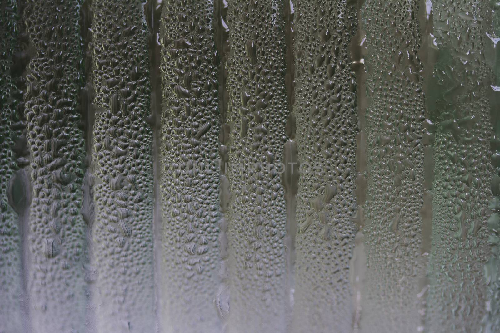 a jar covered with water condensation droplets lined up 