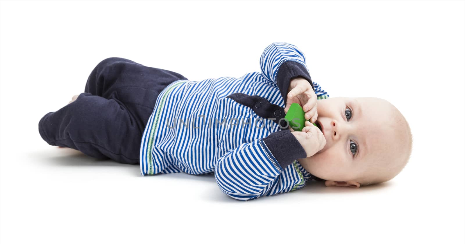 vertical image of toddler lying on floor. isolated on white background