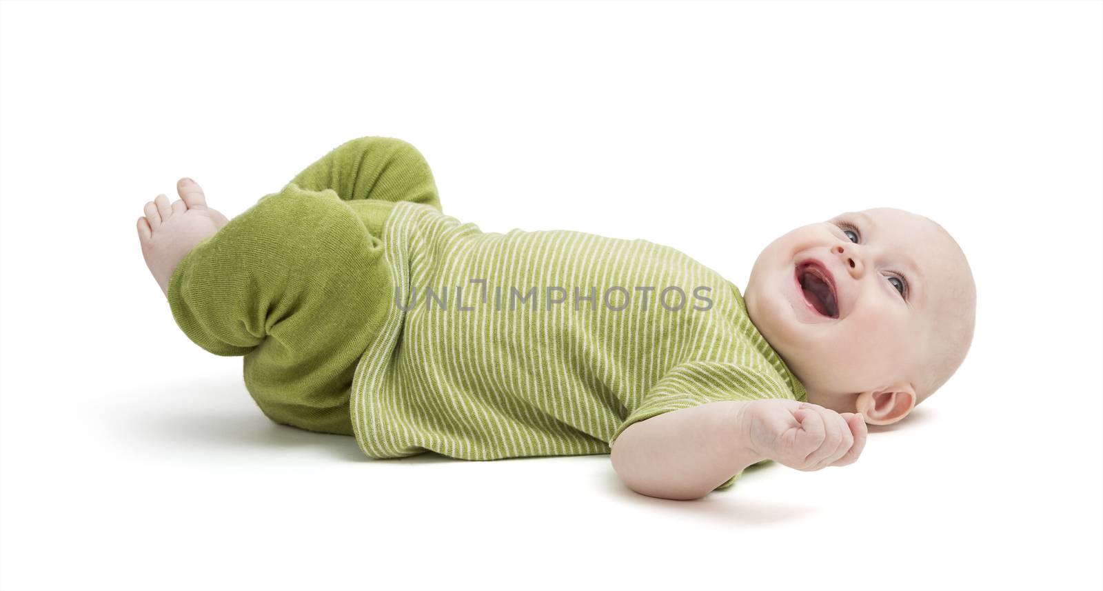 happy, laughing toddler laying on back isolated on white background