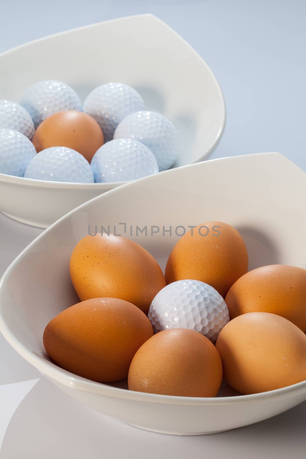 White bowls, easter eggs and golf balls by CaptureLight