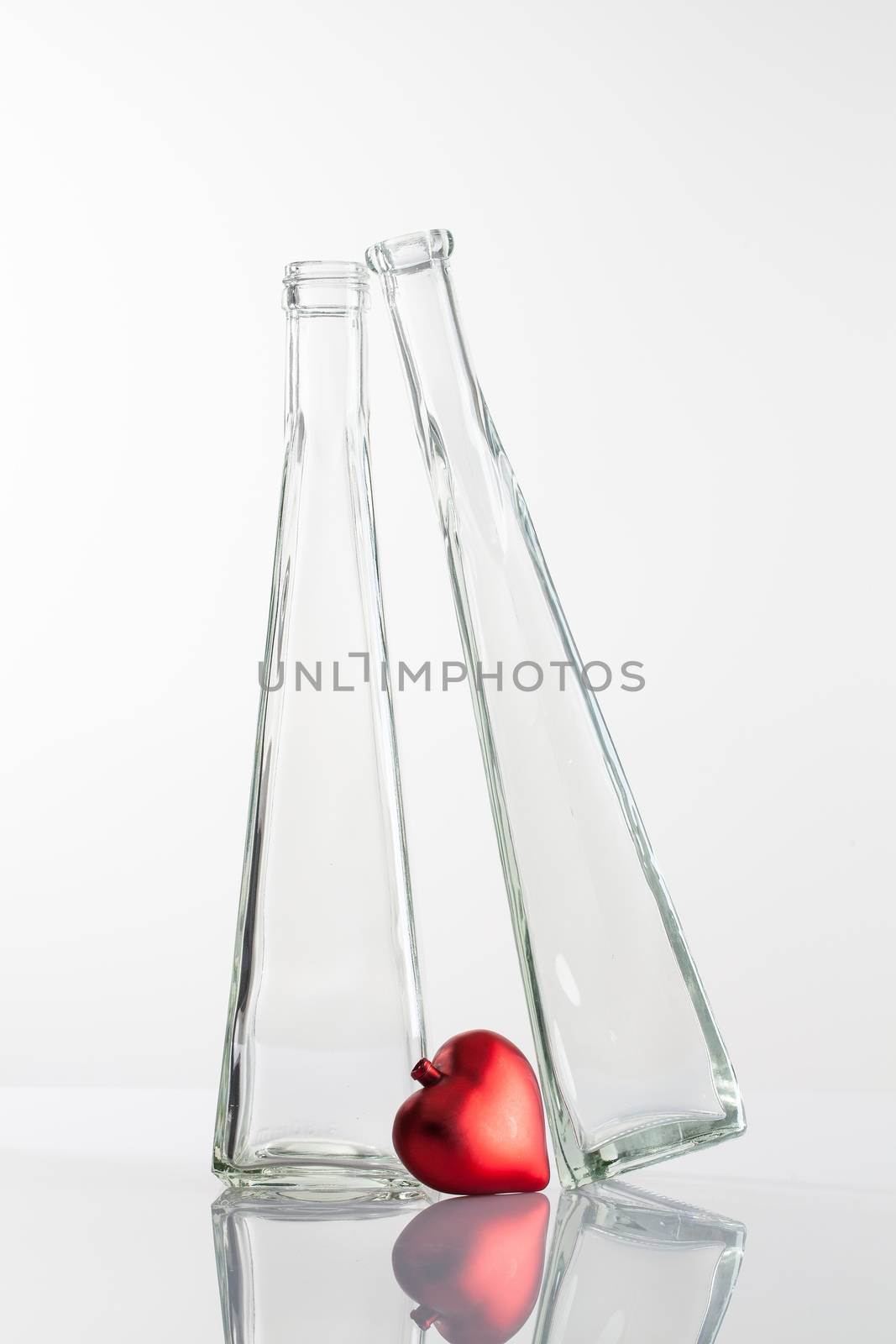 (Couple in Love) Two glasses and red heart on a glass table