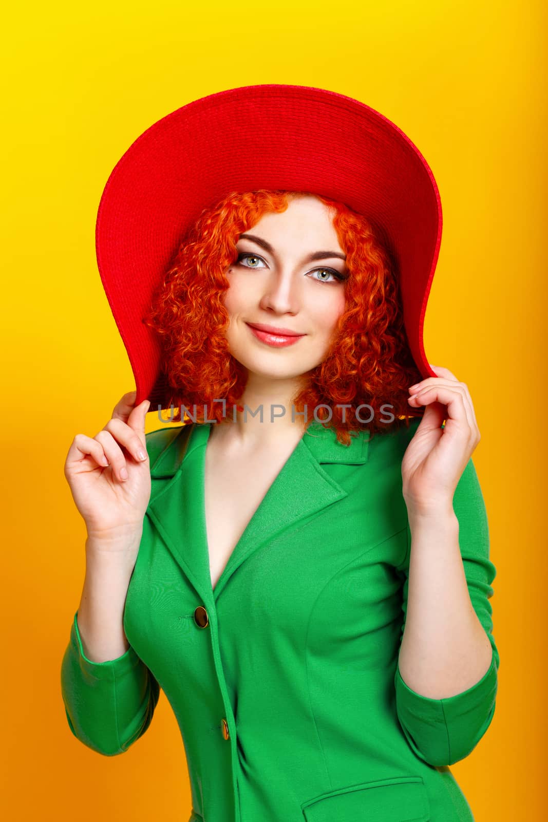 Attractive red-haired girl in red shady hat shot closeup