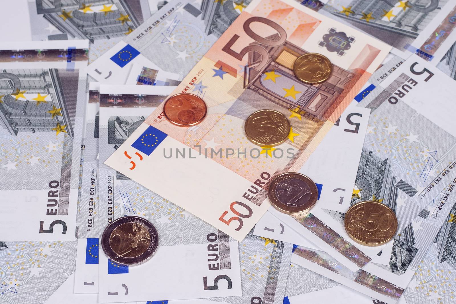 The European currency: banknotes of five and fifty euros and coins