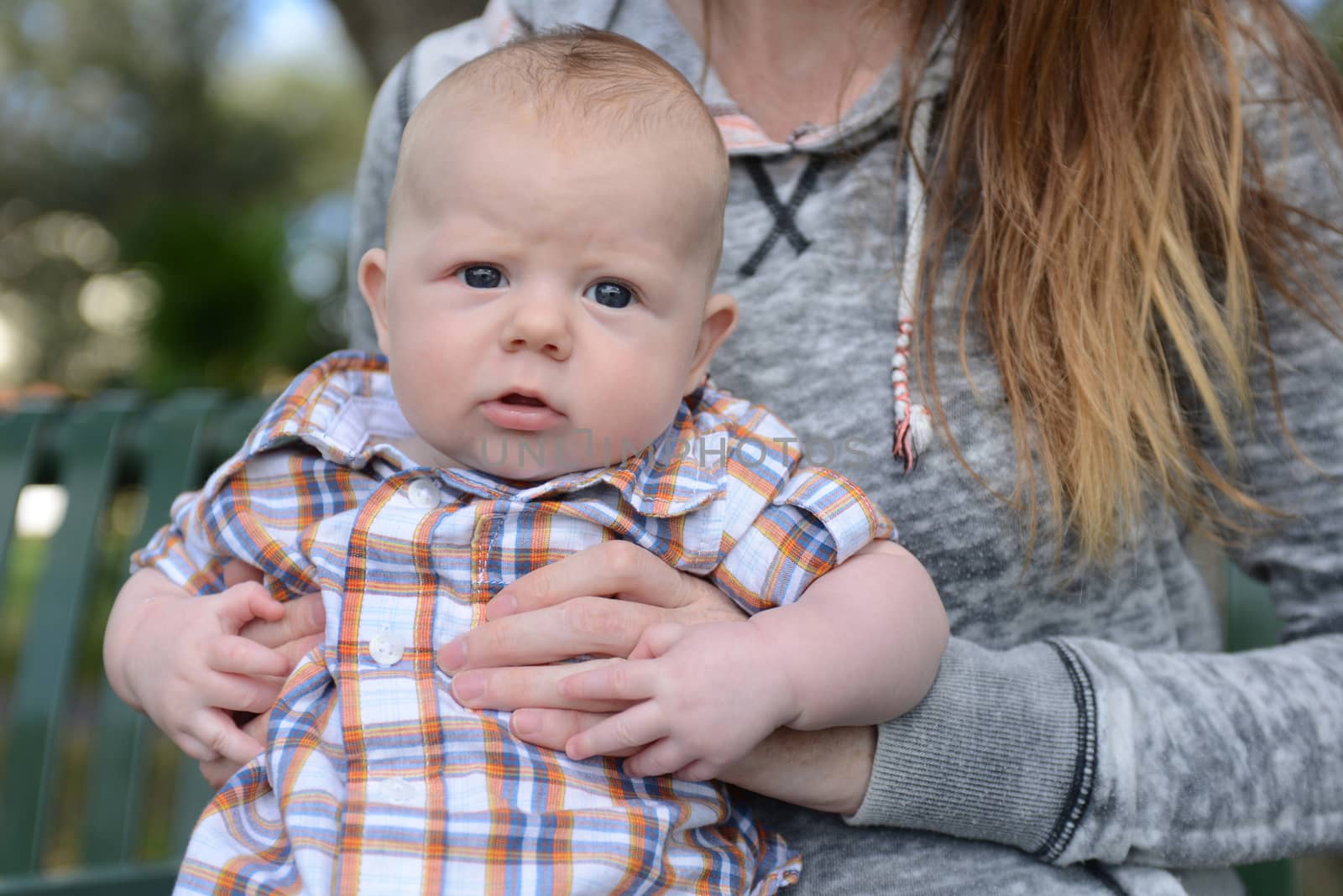 cute baby boy with blue eyes and dazed expression