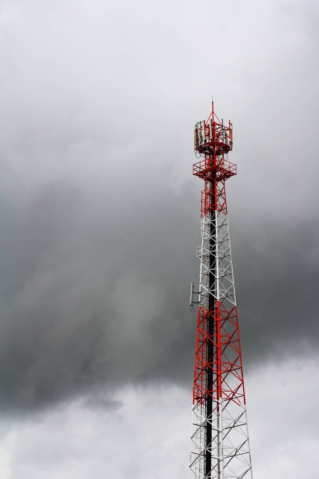 Telecommunications tower in rain cloud