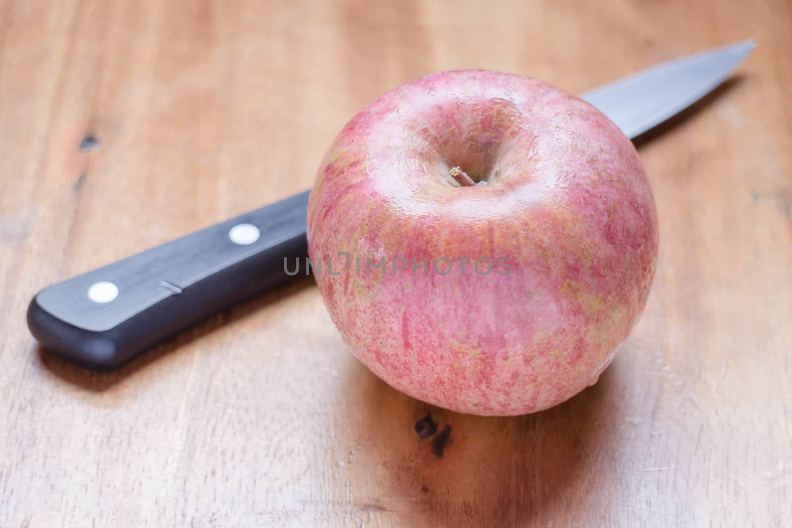 Fresh apple on wooden table, stock photo