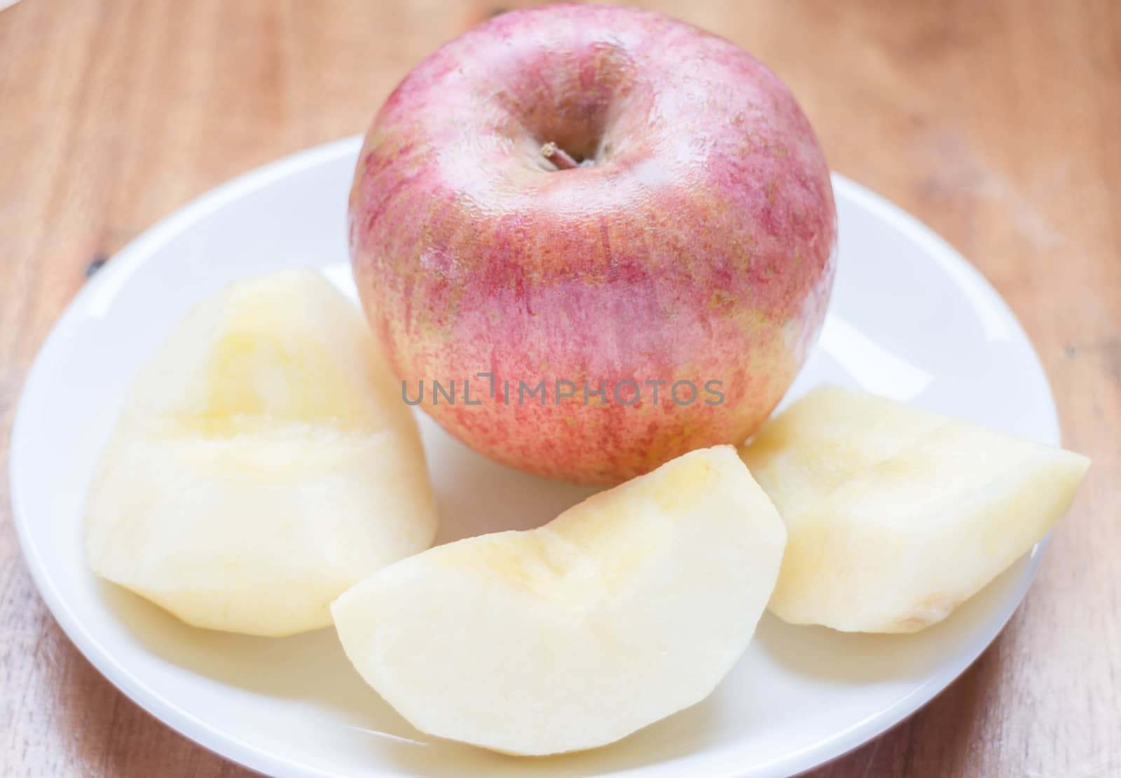 Red apple peeled on the dish, stock photo