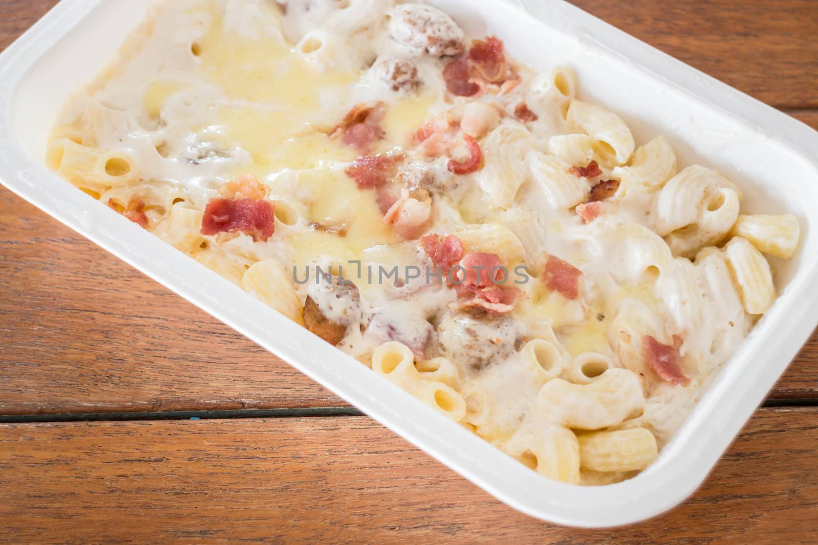 Macaroni cheese with pork ball and ham in the box, stock photo