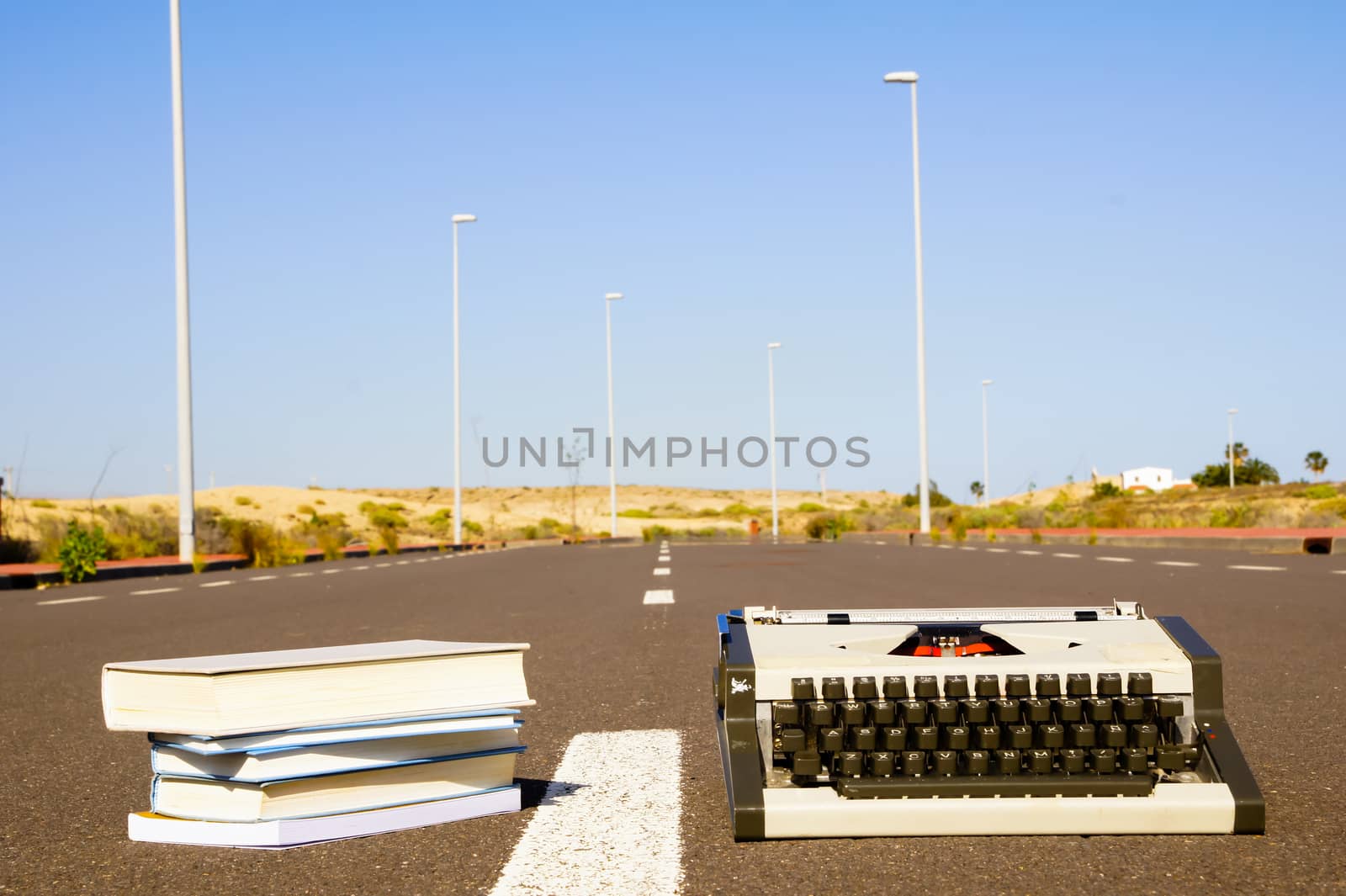 On the Road Writing Concept Typewriter over an Asphalt Street
