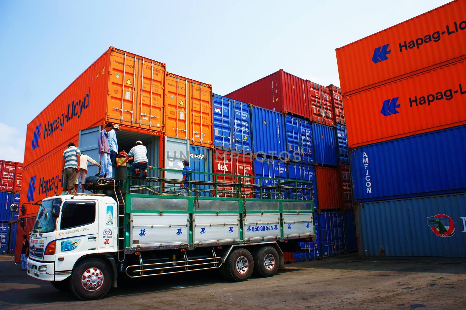 HO CHI MINH CITY, VIET NAM- MAR 19 :  Truck load cargo from container at freight depot, cargo box in stack, this industrial port is logistic service of import, export  goods ,Vietnam, Mar 19, 2014