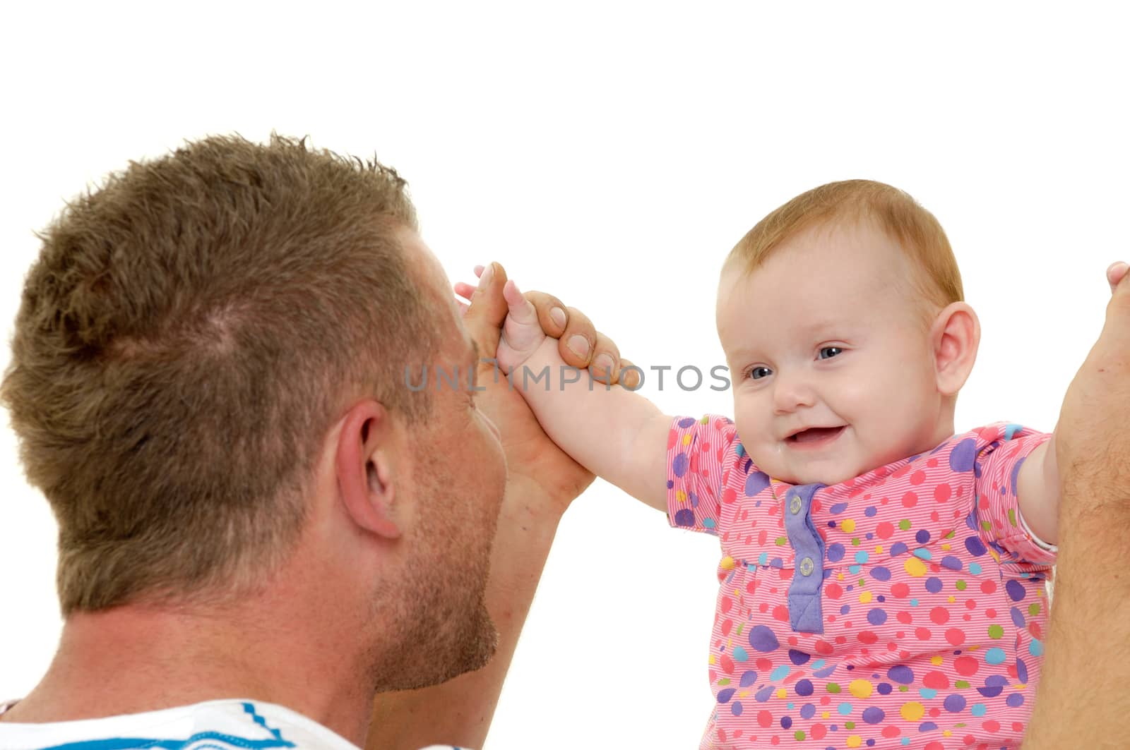 Baby and father are playing. They are both smiling and are very happy together.  The baby 3 month old. Isolated on a white background.