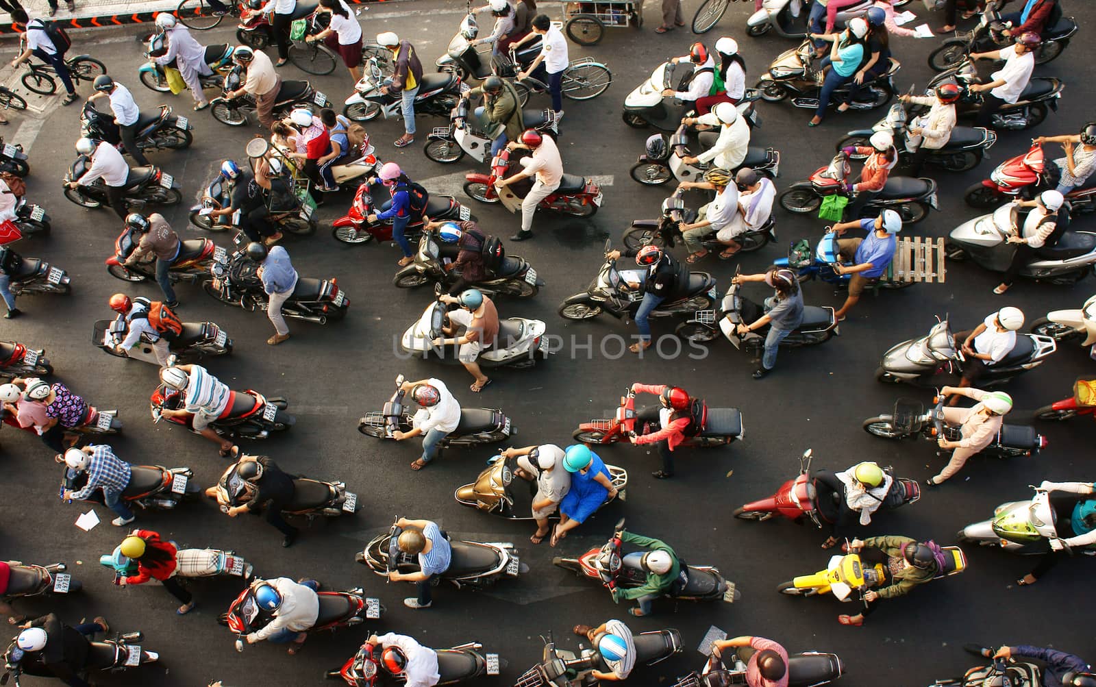 HO CHI MINH CITY, VIET NAM- MAR 27: Dense, crowed  scene of city traffic  in rush hour, crowd of people wear helmet, transport by motorcycles, stop at red light in stress situation, Vietnam, Mar 27, 2014