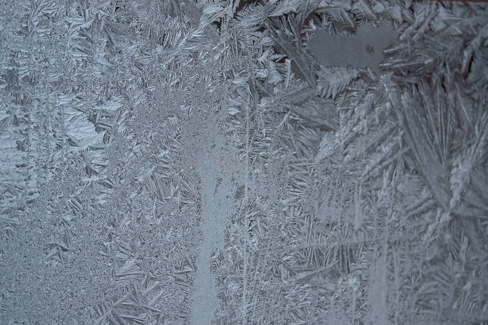 View of  frost on  glass window. Image with shallow depth of field.