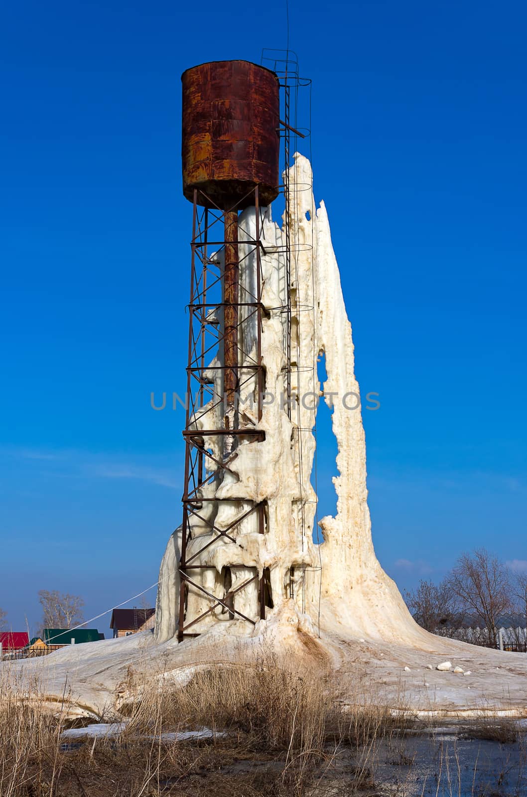 Water tower with ice and with  large icicle, Russia.