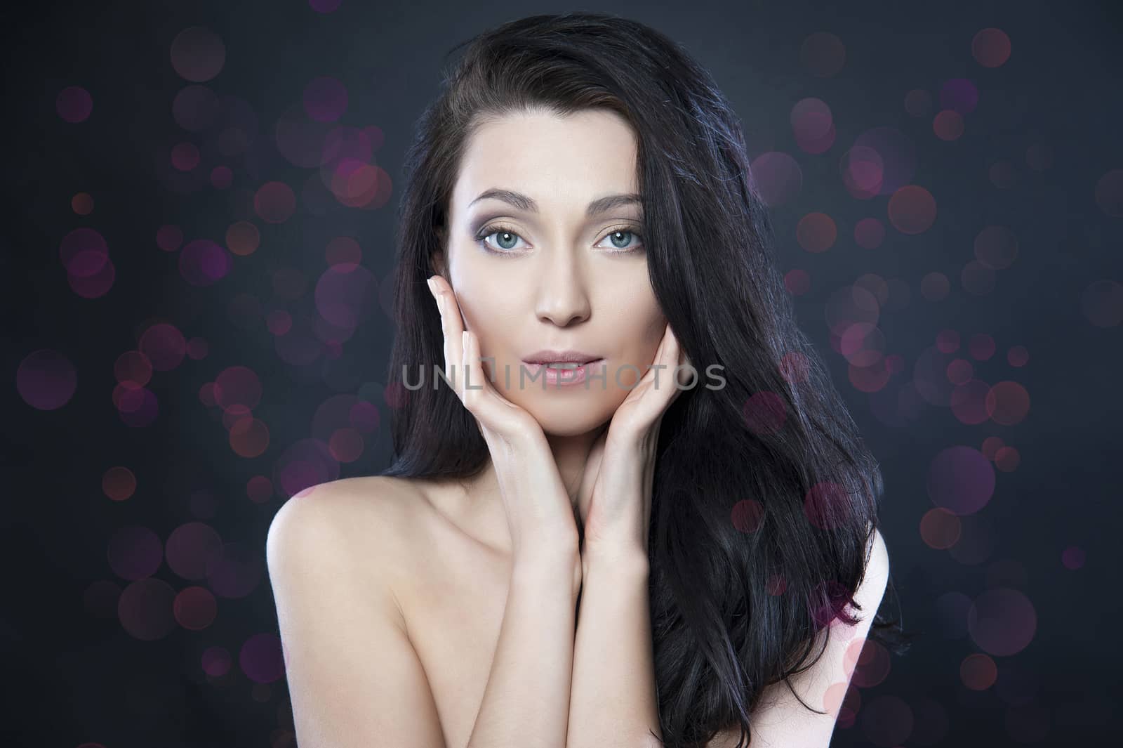 beautiful woman with blue eyes on a black background bokeh