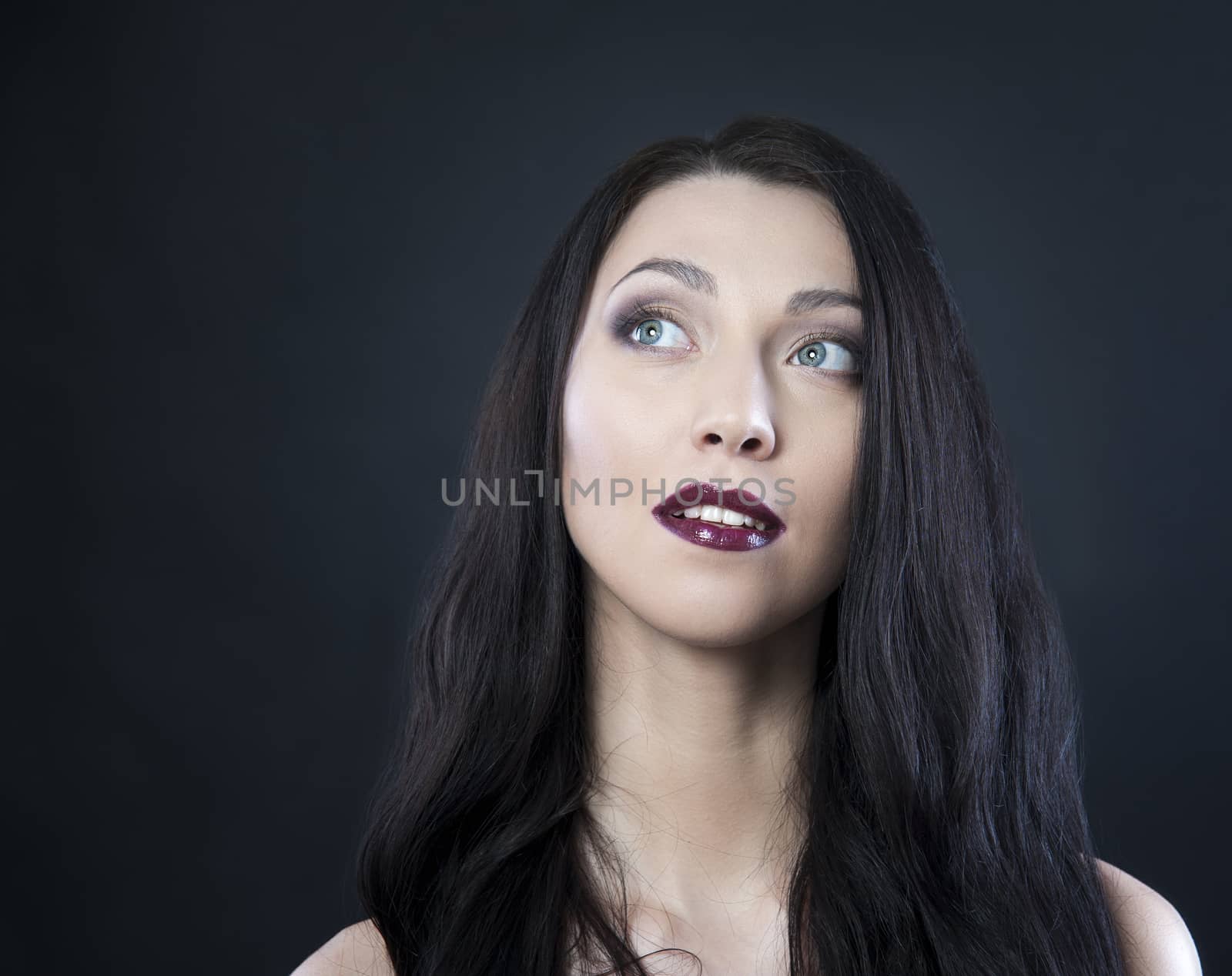 beautiful woman with blue eyes on a black background