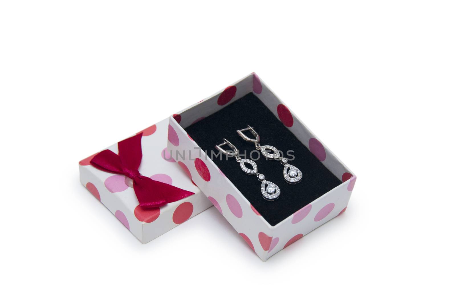 Silver earrings in a box isolated on white background  by cocoo