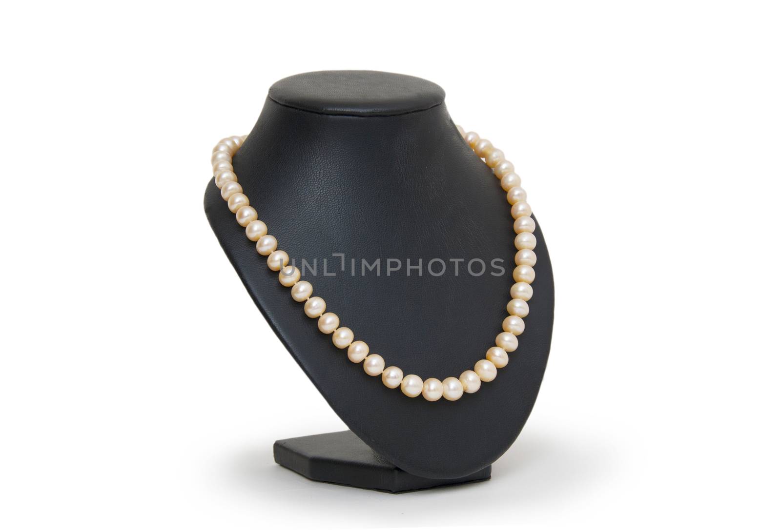 Pearl necklace on black mannequin isolated by cocoo