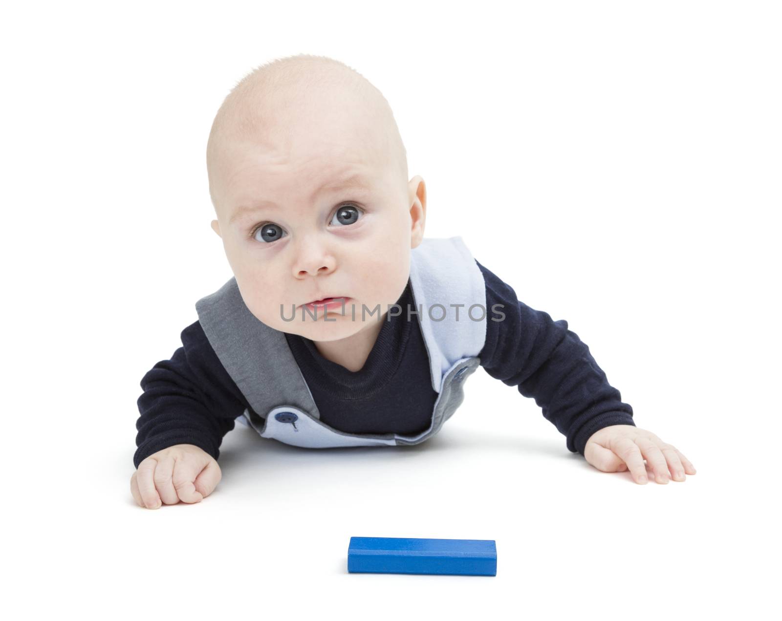 interested baby with toy block on floor isolated on white