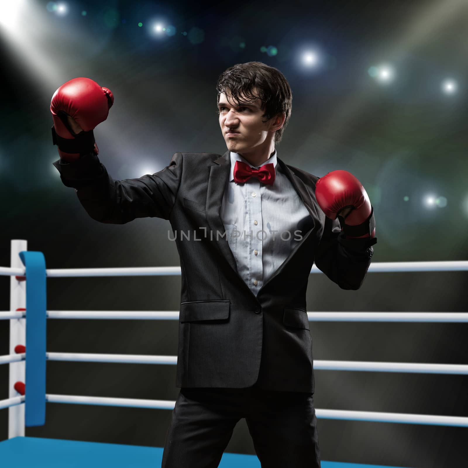 image of a businessman with boxing gloves in the ring, the competition in the business