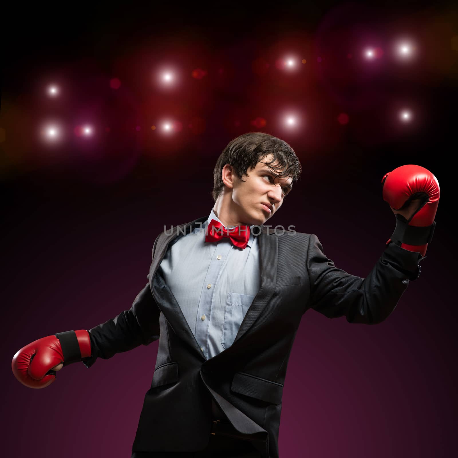 image of a businessman with boxing gloves in the ring, the competition in the business