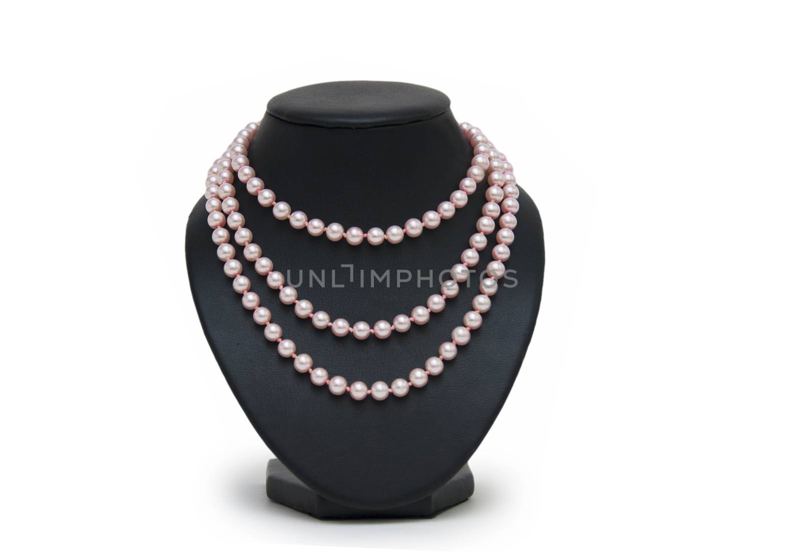 Pearl necklace on black mannequin isolated  by cocoo