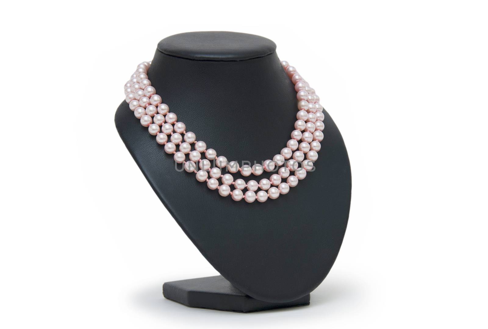 Pearl necklace on black mannequin isolated  by cocoo