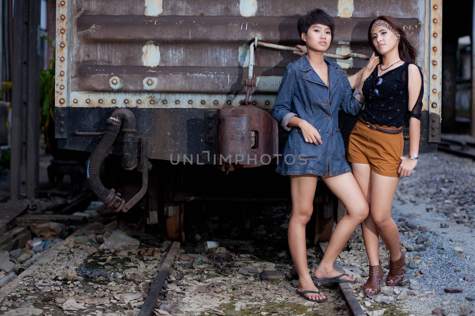 fashion portrait asian two girl in train station.portrait fashion on outdoor.