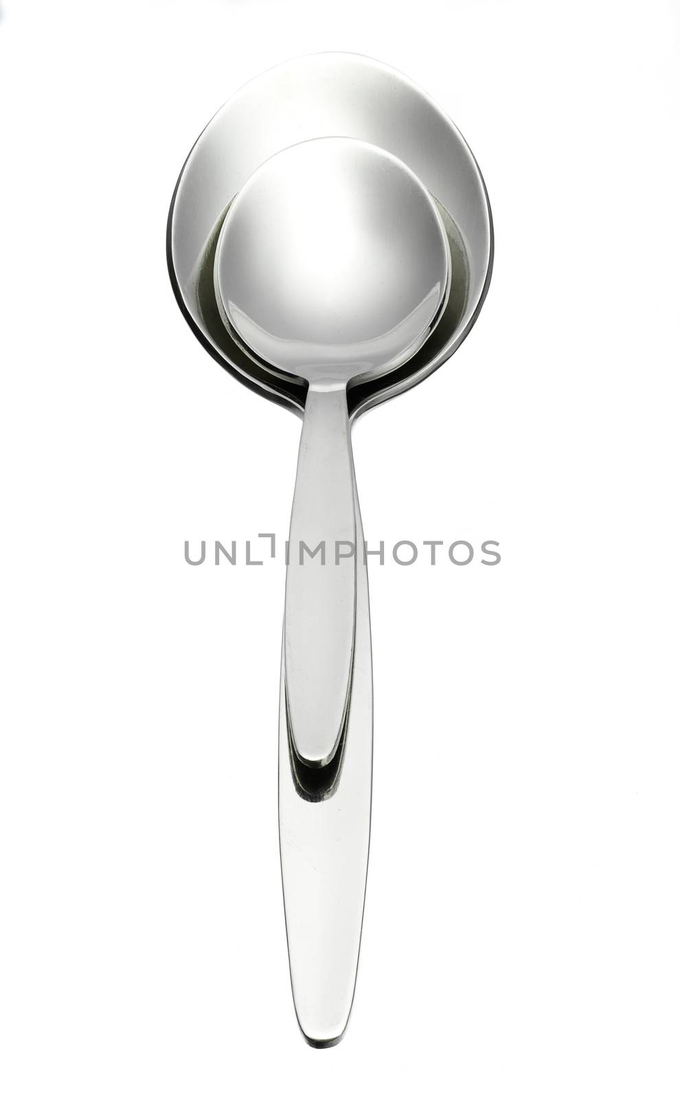 two shiny steel spoon over white background