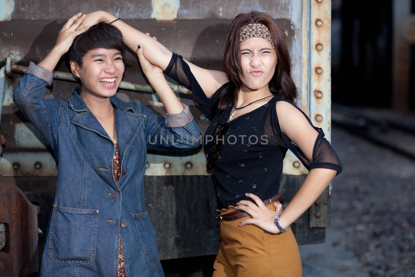 fashion portrait asian two girl in train station.portrait fashion on outdoor.