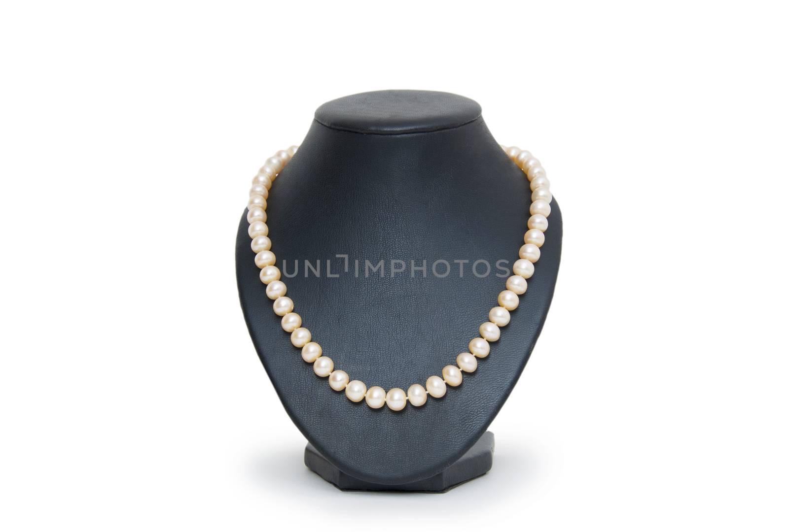 Pearl necklace on black mannequin isolated  by cocoo