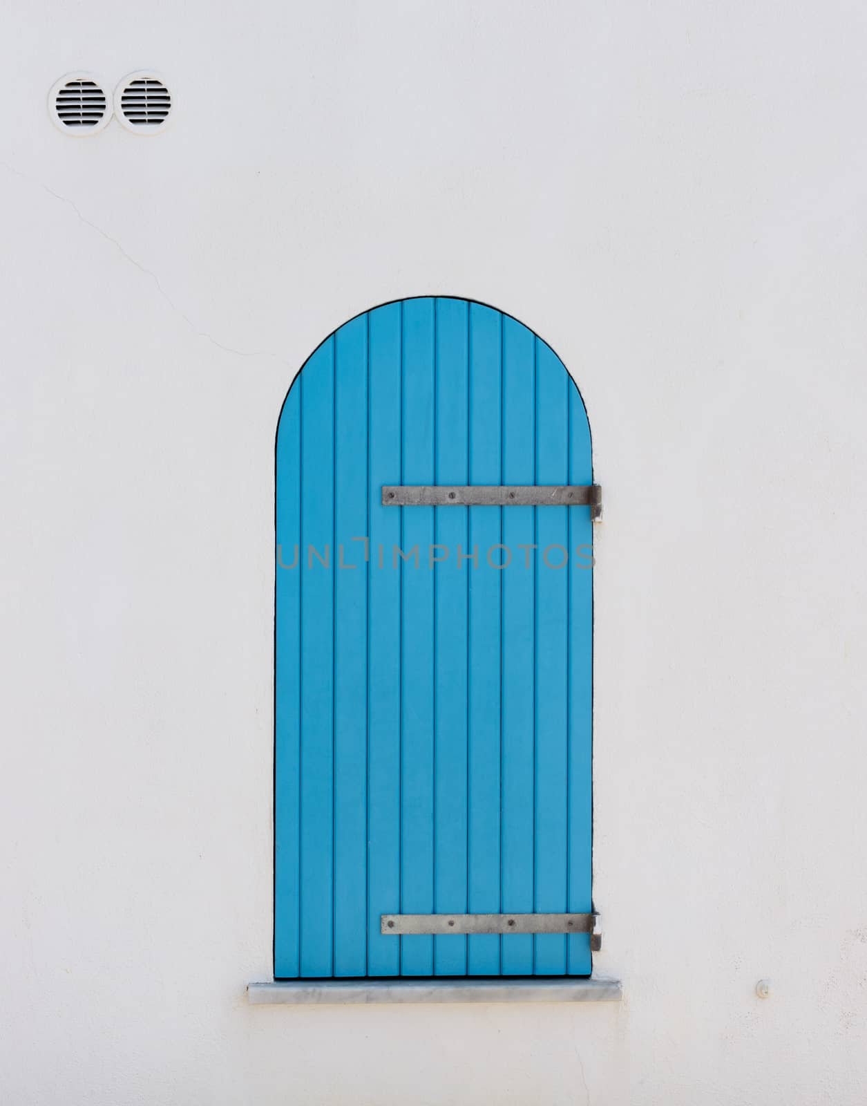 Colored panel of a wooden window typical of the seaside in Sardinia