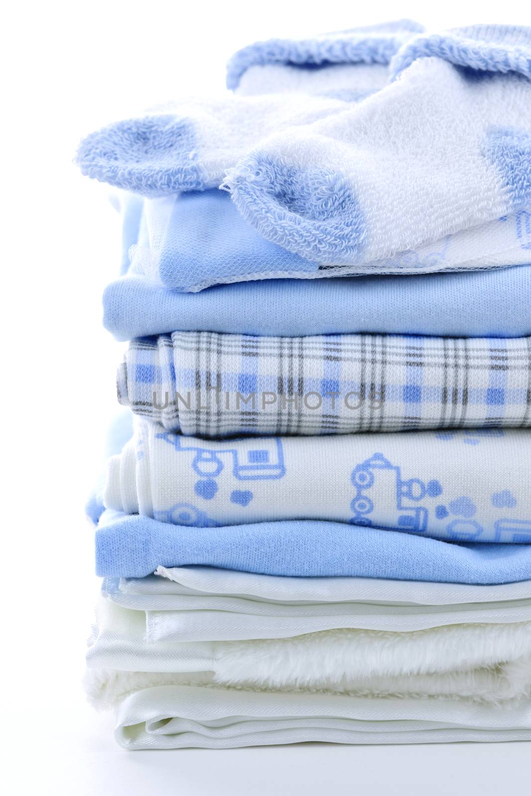 Stack of blue infant clothing for baby shower