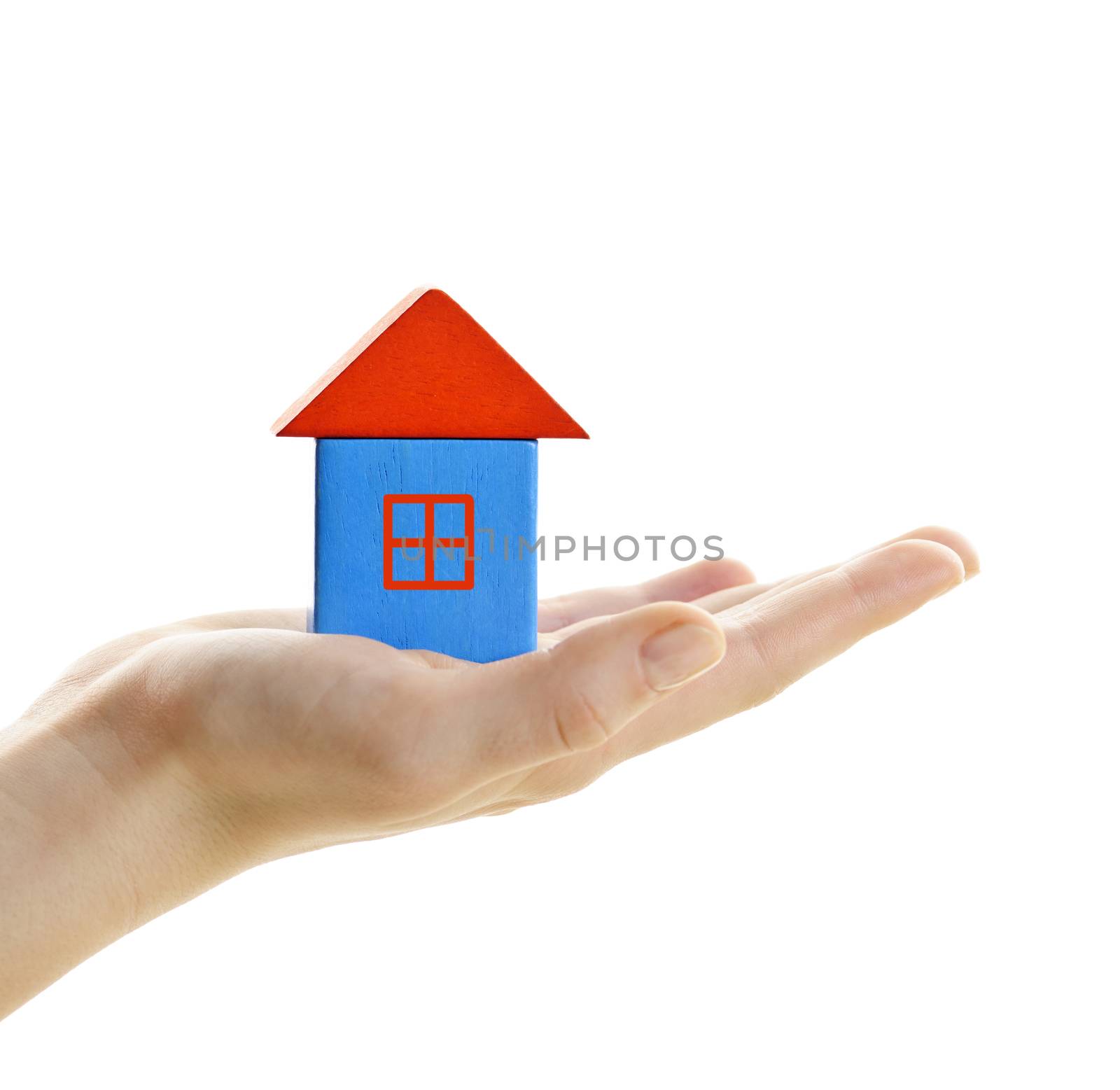 Hand holding wooden block house isolated on white background