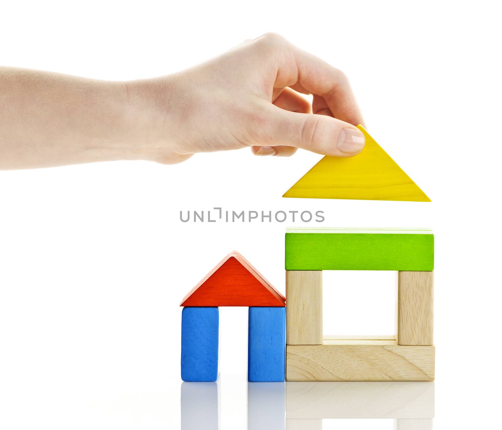 Wooden block houses under construction isolated on white background