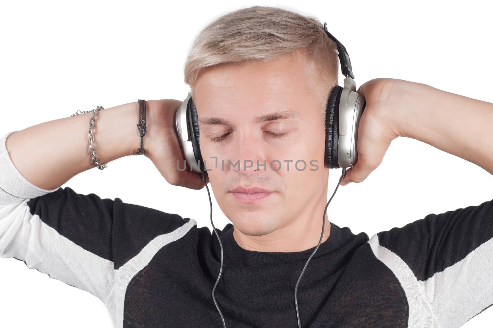 Young blond man in headphones with closed eyes by anytka
