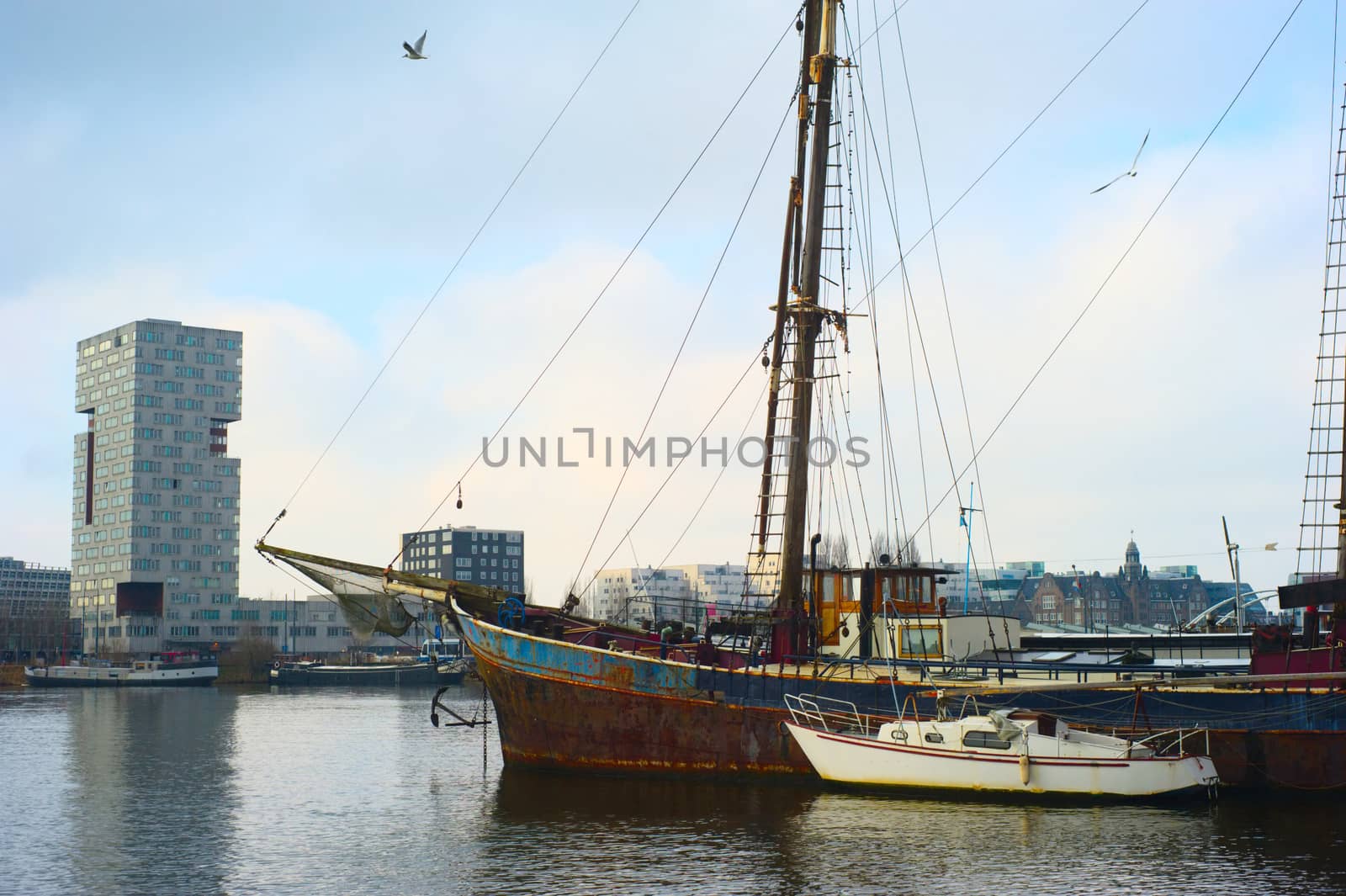 Rusty ship in Amsterdam harbor by joyfull