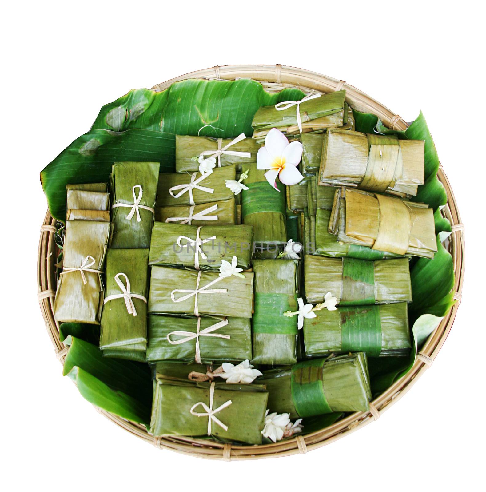 Thai dessert like a rice soup with bound,Bananas with Sticky Rice,steamed rice dough with sweet stuffing,Steamed toddy palm cake stuffed dumping are wrapping with banana leaf and decorate in basket.