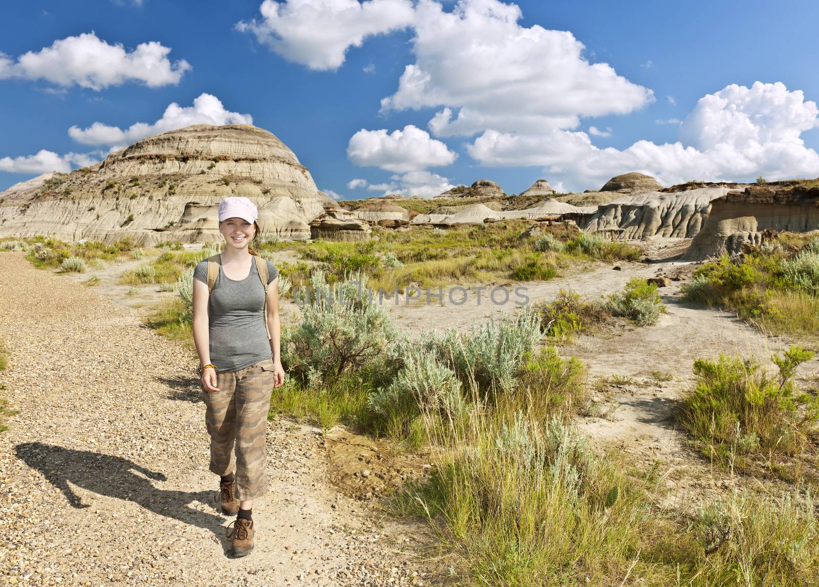 Happy girl hiking the Badlands in Dinosaur provincial park, Alberta, Canada