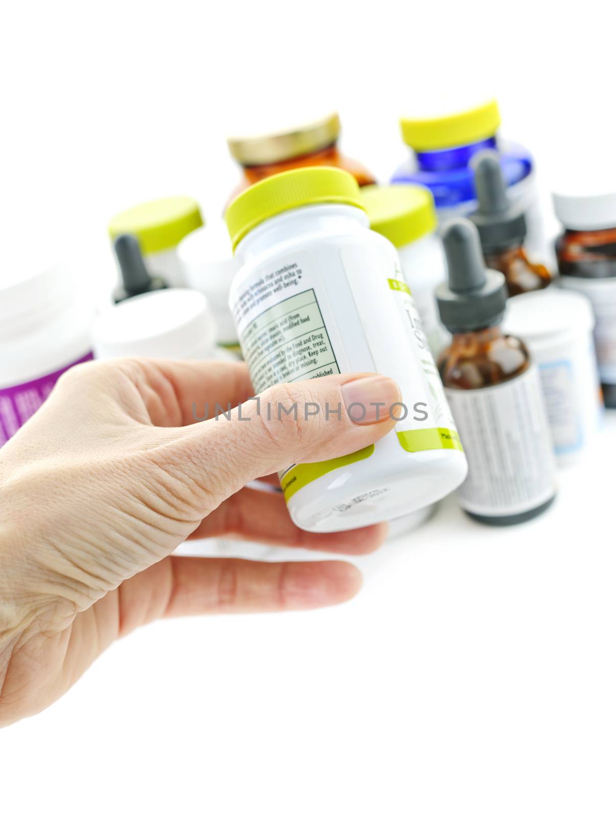 Hand holding medicine bottle to read label