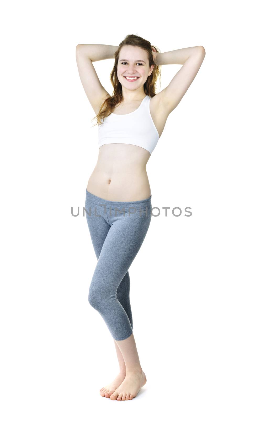 Smiling fit young woman standing isolated on white