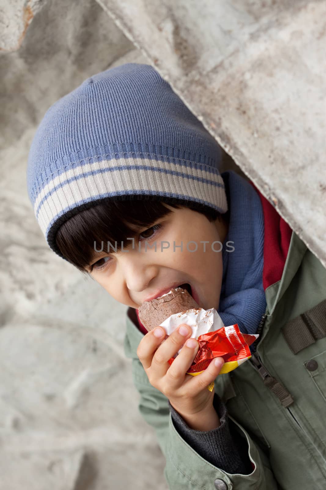 little boy in knitted cap eating ice cream