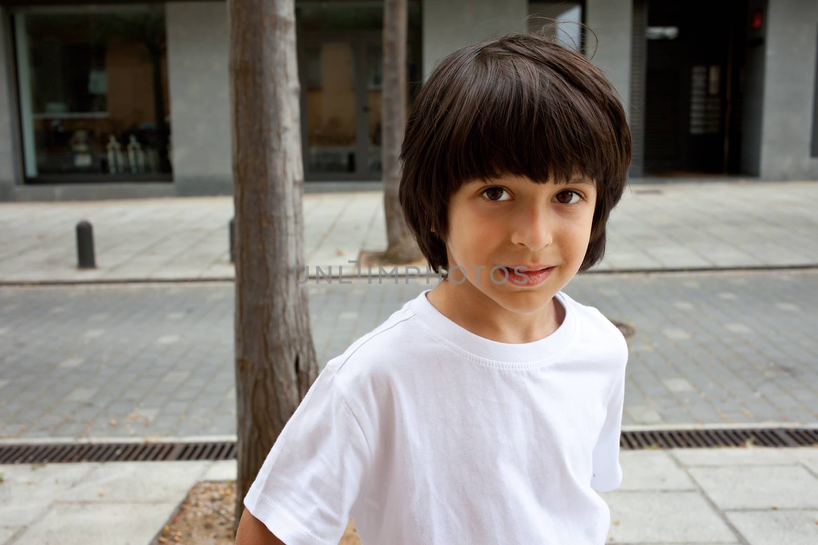 european boy in a white T-shirt on the street