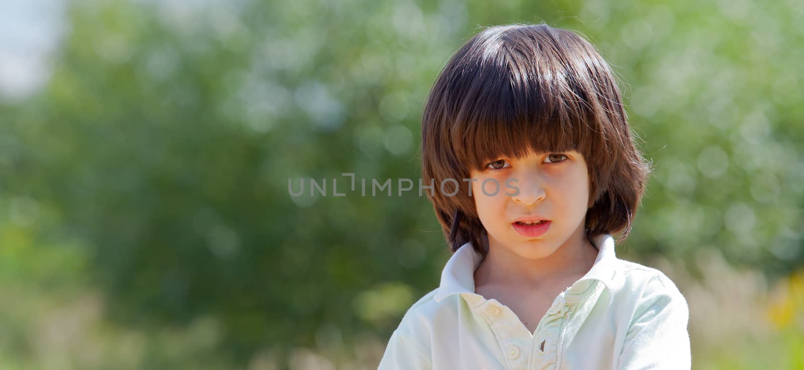 Portrait of a boy on a green background